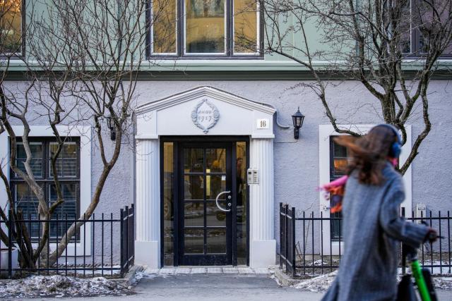 A woman passes by a residential building with the apartment of Former Prime Minister of Norway Thorbjorn Jagland in Oslo on February 12, 2026. Norwegian police said they had searched properties belonging to former prime minister Thorbjorn Jagland following the launch of a corruption probe over his dealings with US sex offender Jeffrey Epstein. Jagland is being investigated after documents released by the US Justice Department in January suggested that he and/or his family stayed or vacationed with Epstein between 2011 and 2018. (Photo by Stian Lysberg Solum / NTB / AFP) / Norway OUT