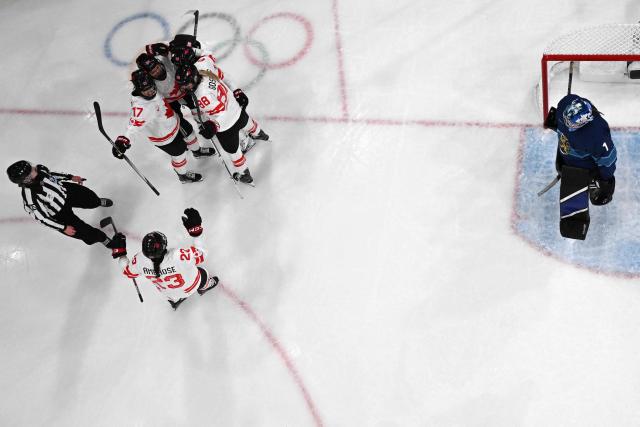 Canada's forward #94 Jennifer Gardiner celebrates with teammates after scoring during the women's preliminary round Group A Ice Hockey match between Finland and Canada at the Milano Rho Ice Hockey Arena during the Milano Cortina 2026 Winter Olympic Games in Milan, on February 12, 2026. (Photo by Piero CRUCIATTI / AFP)