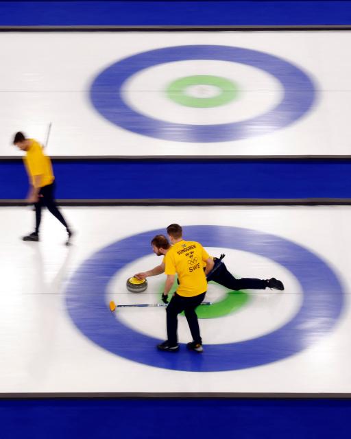 (front to back)  Sweden's Christoffer Sundgren and team mates compete in the curling men's round robin between Britain and Sweden during the Milano Cortina 2026 Winter Olympic Games at the Cortina Curling Olympic Stadium in Cortina d’Ampezzo on February 12, 2026. (Photo by Odd ANDERSEN / AFP)