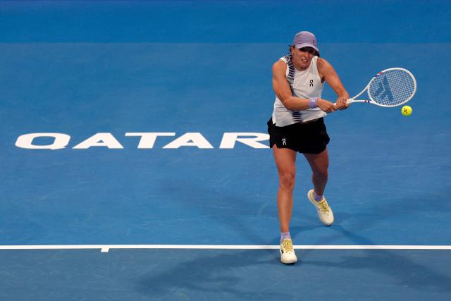 Poland's Iga Swiatek returns a shot during her women’s singles quarter-final match against Greece's Maria Sakkari at the Qatar Open tennis tournament in Doha on February 12, 2026. (Photo by Karim JAAFAR / AFP)