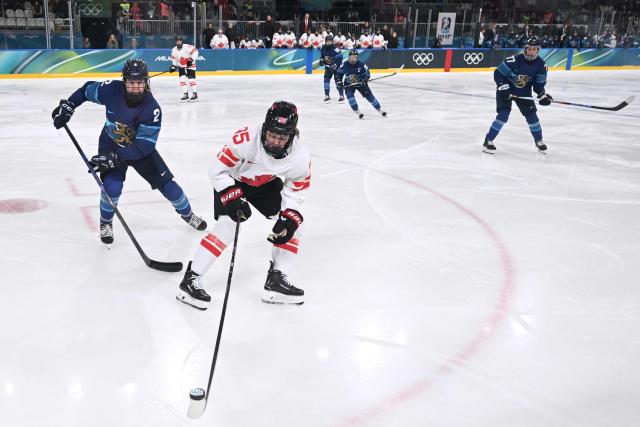 Canada's forward #95 Daryl Watts and Finland's #02 Sini Karjalainent vie for the puck during the women's preliminary round Group A Ice Hockey match between Finland and Canada at the Milano Rho Ice Hockey Arena during the Milano Cortina 2026 Winter Olympic Games in Milan, on February 12, 2026. (Photo by PIERO CRUCIATTI / AFP)