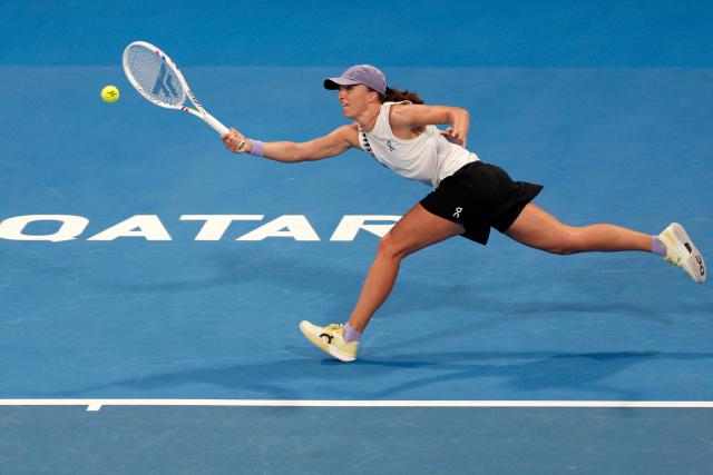 Poland's Iga Swiatek returns a shot during her women’s singles quarter-final match against Greece's Maria Sakkari at the Qatar Open tennis tournament in Doha on February 12, 2026. (Photo by Karim JAAFAR / AFP)