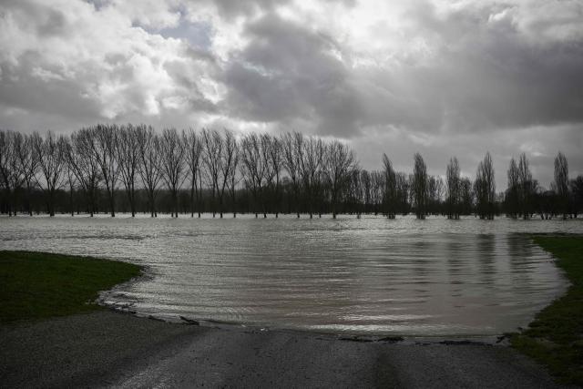 This photograph shows a flooded area in Marmande, south-western France, on February 12, 2026, as storm Nils triggers exceptional flooding along the Garonne river with authorities maintaining red alert status across the Gironde department. Accompanied by winds exceeding 160 km/h, Storm Nils swept across several regions of France on Thursday, causing the death of a lorry driver in the Landes and damage, leaving 850,000 homes without electricity, particularly in the southwest. (Photo by Philippe LOPEZ / AFP)