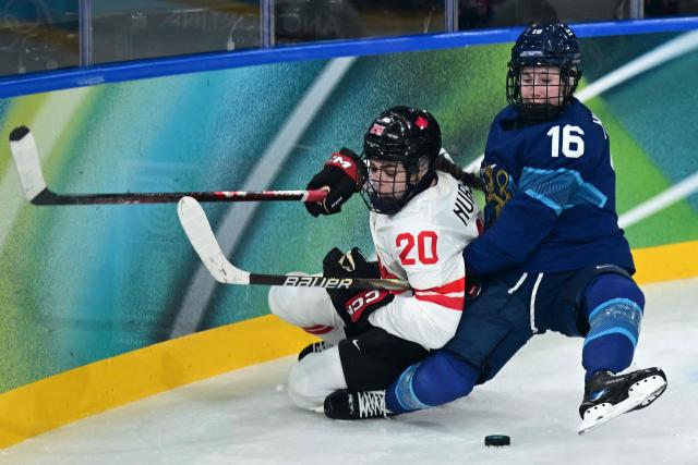 Canada's forward #20 Sarah Nurse and Finland's #16 Petra Nieminen vie for the puck during the women's preliminary round Group A Ice Hockey match between Finland and Canada at the Milano Rho Ice Hockey Arena during the Milano Cortina 2026 Winter Olympic Games in Milan, on February 12, 2026. (Photo by Piero CRUCIATTI / AFP)