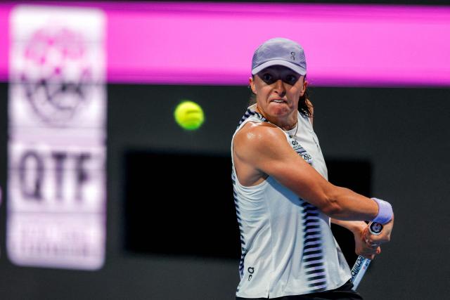 Poland's Iga Swiatek returns a shot during her women’s singles quarter-final match against Greece's Maria Sakkari at the Qatar Open tennis tournament in Doha on February 12, 2026. (Photo by Karim JAAFAR / AFP)