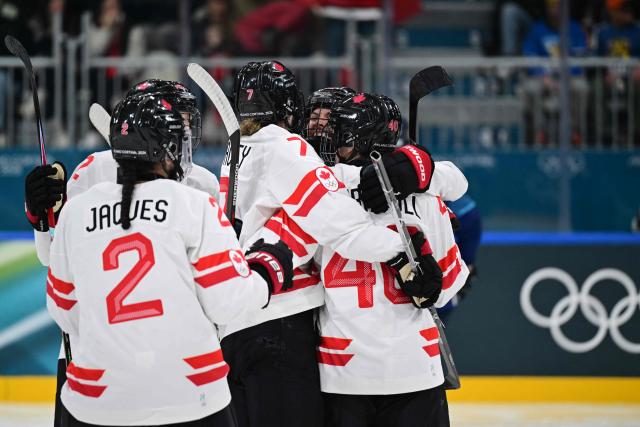 Canada's forward #26 Emily Clark celebrates with teammates after scoring a goal during the women's preliminary round Group A Ice Hockey match between Finland and Canada at the Milano Rho Ice Hockey Arena during the Milano Cortina 2026 Winter Olympic Games in Milan, on February 12, 2026. (Photo by Piero CRUCIATTI / AFP)