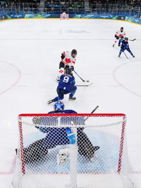 Canada's forward #94 Jennifer Gardiner scores during the women's preliminary round Group A Ice Hockey match between Finland and Canada at the Milano Rho Ice Hockey Arena during the Milano Cortina 2026 Winter Olympic Games in Milan, on February 12, 2026. (Photo by Sun Fei / POOL / AFP)