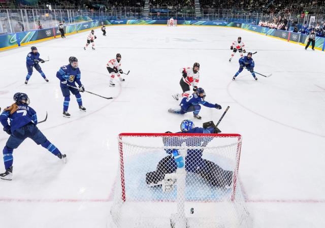 Canada's forward #94 Jennifer Gardiner scores during the women's preliminary round Group A Ice Hockey match between Finland and Canada at the Milano Rho Ice Hockey Arena during the Milano Cortina 2026 Winter Olympic Games in Milan, on February 12, 2026. (Photo by Sun Fei / POOL / AFP)