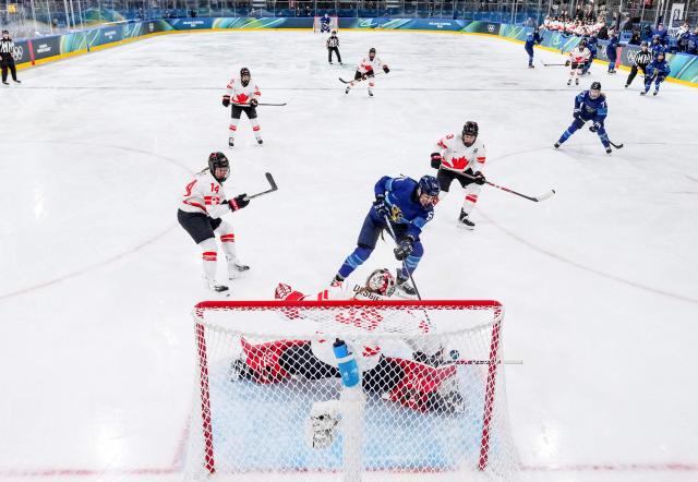 Finland's #61 Emma Nuutinen tries to score against Canada's goalkeeper #35 Ann-Renee Desbiens during the women's preliminary round Group A Ice Hockey match between Finland and Canada at the Milano Rho Ice Hockey Arena during the Milano Cortina 2026 Winter Olympic Games in Milan, on February 12, 2026. (Photo by Sun Fei / POOL / AFP)