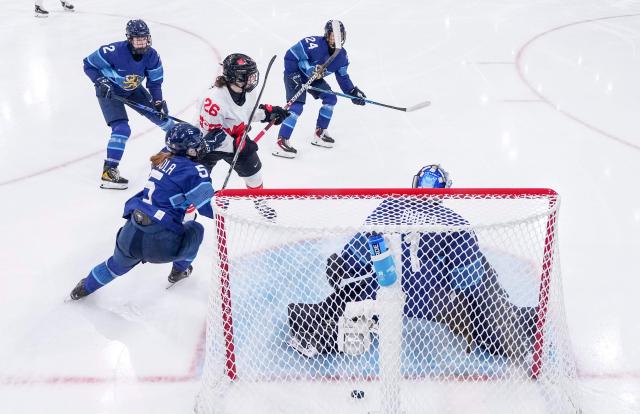 Canada's forward #26 Emily Clark scores during the women's preliminary round Group A Ice Hockey match between Finland and Canada at the Milano Rho Ice Hockey Arena during the Milano Cortina 2026 Winter Olympic Games in Milan, on February 12, 2026. (Photo by Sun Fei / POOL / AFP)