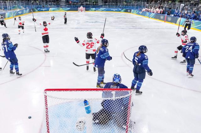 Canada's forward #26 Emily Clark celebrates with teammates after scoring during the women's preliminary round Group A Ice Hockey match between Finland and Canada at the Milano Rho Ice Hockey Arena during the Milano Cortina 2026 Winter Olympic Games in Milan, on February 12, 2026. (Photo by Sun Fei / POOL / AFP)