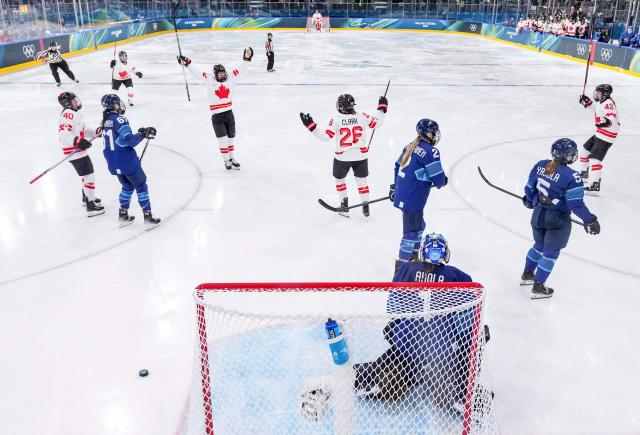 Canada's forward #26 Emily Clark celebrates with teammates after scoring during the women's preliminary round Group A Ice Hockey match between Finland and Canada at the Milano Rho Ice Hockey Arena during the Milano Cortina 2026 Winter Olympic Games in Milan, on February 12, 2026. (Photo by Sun Fei / POOL / AFP)