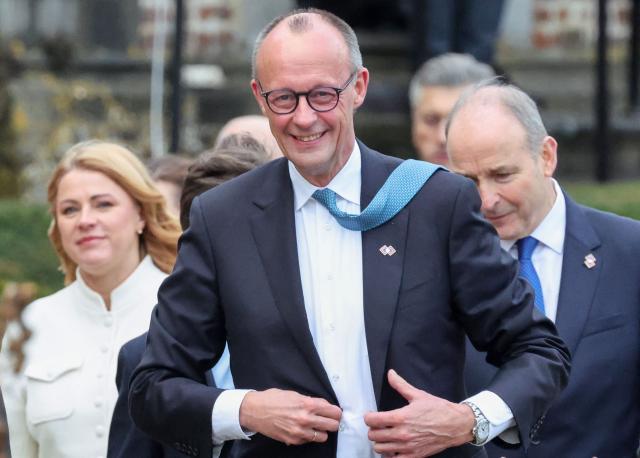 Germany's Chancellor Friedrich Merz arrives for a family photo as part of the Informal EU Leaders' Retreat at the Alden Biesen Castle, in Rijkhoven on February 12, 2026. (Photo by Ludovic MARIN / AFP)