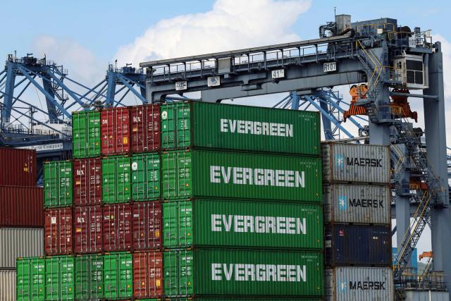 Evergreen cargo shipping containers stand stacked at the port of Balboa in Panama City on February 12, 2026. Hong Kong-based conglomerate CK Hutchison warned on February 12 of possible legal action against Danish firm Maersk and others over the annulment of its contract to operate two ports on the Panama Canal. (Photo by MARTIN BERNETTI / AFP)
