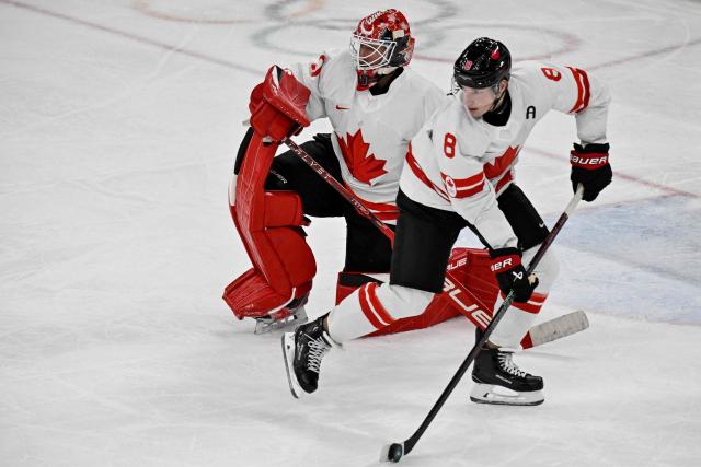 Canada's #08 Cale Makar controls the puck during the men's preliminary round Group A Ice Hockey match between Czech Republic and Canada at the Milano Santagiulia Ice Hockey Arena during the Milano Cortina 2026 Winter Olympic Games in Milan, on February 12, 2026. (Photo by Alexander NEMENOV / AFP)