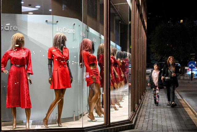 Red dresses are on display in the window of a clothing shop in Lebanon's northern city of Byblos on February 12, 2026, ahead of Valentine's Day. (Photo by JOSEPH EID / AFP)