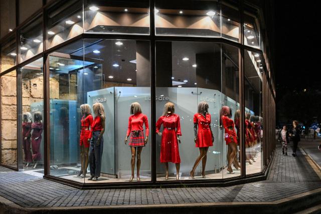 Red dresses are on display in the window of a clothing shop in Lebanon's northern city of Byblos on February 12, 2026, ahead of Valentine's Day. (Photo by JOSEPH EID / AFP)