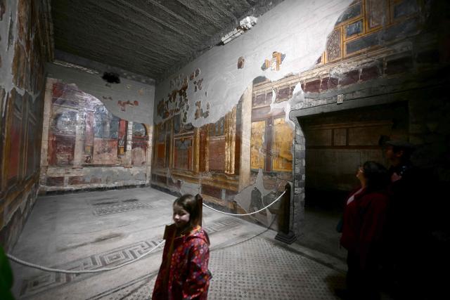 Tourists visit the 1st century BC luxurious residence of Poppaea Sabina (Poppea), second wife of the Emperor Nero, in Pompeii on Febuary 12, 2026. The construction site of Poppaea's Villa in Oplontis is about to open its doors for a special guided tour that will allow visitors to discover one of the best-preserved treasures of the Pompeii Archaeological Park, observing firsthand the important excavation and consolidation work underway at the site. (Photo by FILIPPO MONTEFORTE / AFP)