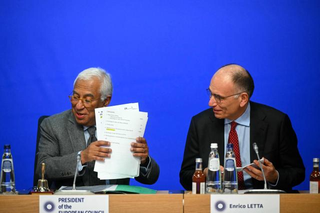 Former Prime Minister of Italy Enrico Letta and European Council President Antonio Costa react during a working session as part of the Informal EU Leaders' Retreat at the Alden Biesen Castle, in Rijkhoven on February 12, 2026. (Photo by NICOLAS TUCAT / POOL / AFP)