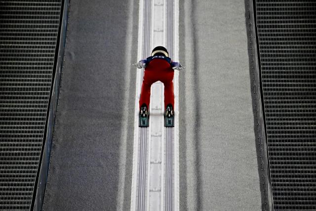 Austria's Lisa Eder slides down the inrun track during the women's ski jumping large hill training of the Milano Cortina 2026 Winter Olympic Games at Predazzo Ski Jumping Stadium in Predazzo (Val di Fiemme), on February 12, 2026. (Photo by Tobias SCHWARZ / AFP)