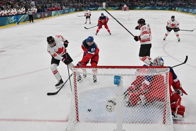 Canada's #61 Mark Stone (L) fights for the puck with Czech Republic's #81 Dominik Kubalik (2nd L) in front of Czech Republic's #01 Lukas Dostal during the men's preliminary round Group A Ice Hockey match between Czech Republic and Canada at the Milano Santagiulia Ice Hockey Arena during the Milano Cortina 2026 Winter Olympic Games in Milan, on February 12, 2026. (Photo by Alexander NEMENOV / POOL / AFP)