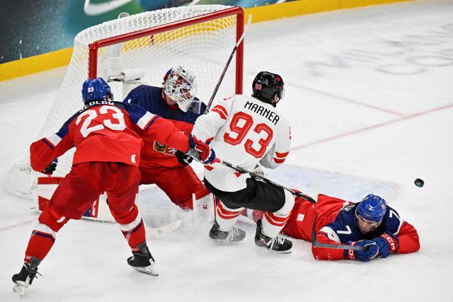 Canada's #93 Mitch Marner (2nd R) fights for the puck with (From L) Czech Republic's #23 Lukas Sedlak, Czech Republic's #01 Lukas Dostal and Czech Republic's #07 David Spacek during the men's preliminary round Group A Ice Hockey match between Czech Republic and Canada at the Milano Santagiulia Ice Hockey Arena during the Milano Cortina 2026 Winter Olympic Games in Milan, on February 12, 2026. (Photo by Alexander NEMENOV / AFP)