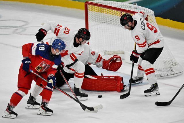 Czech Republic's #18 Ondrej Palat (L) fights for the puck with (From 2n L) Canada's #20 Thomas Harley, Canada's #50 Jordan Binnington and Canada's #09 Sam Bennett during the men's preliminary round Group A Ice Hockey match between Czech Republic and Canada at the Milano Santagiulia Ice Hockey Arena during the Milano Cortina 2026 Winter Olympic Games in Milan, on February 12, 2026. (Photo by Alexander NEMENOV / AFP)