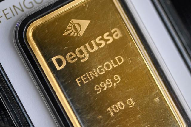 (FILES) A 100g gold bullion bar of the German precious metals trading company Degussa (Deutsche Gold- und Silber-Scheide-Anstalt - German Gold and Silver Refining) is pictured in Dortmund, western Germany on February 9, 2026. Gold fell more than 4% and silver more than 11% on February 12, 2026, ahead of China's market closure for Lunar New Year holidays starting February 13, 2026. (Photo by Ina FASSBENDER / AFP)