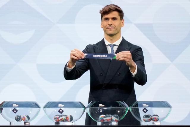 Former Spanish international Fernando Llorente shows up the paper slip for Montenegro during the 2026/27 UEFA Nations League league phase group C draw ceremony as part of the European football governing body's 50th annual Ordinary Congress in Brussels on February 12, 2026. (Photo by Pau BARRENA / AFP)