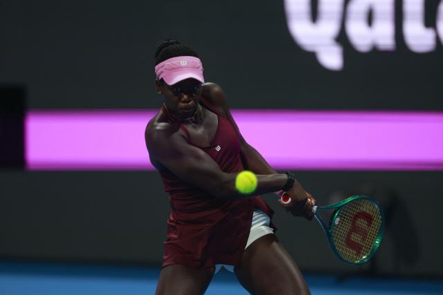 Canada's Victoria Mboko hits a return against Kazakhstan's Elena Rybakina during their women’s singles quarter-final match at the Qatar Open tennis tournament in Doha on February 12, 2026. (Photo by Karim JAAFAR / AFP)