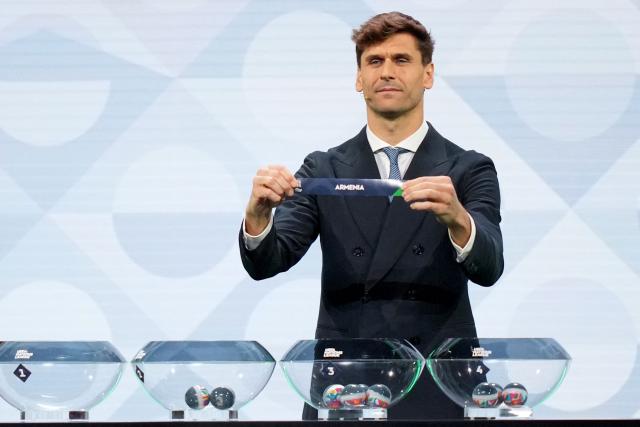 Former Spanish international Fernando Llorente shows up the paper slip for Armenia during the 2026/27 UEFA Nations League league phase group C draw ceremony as part of the European football governing body's 50th annual Ordinary Congress in Brussels on February 12, 2026. (Photo by Pau BARRENA / AFP)