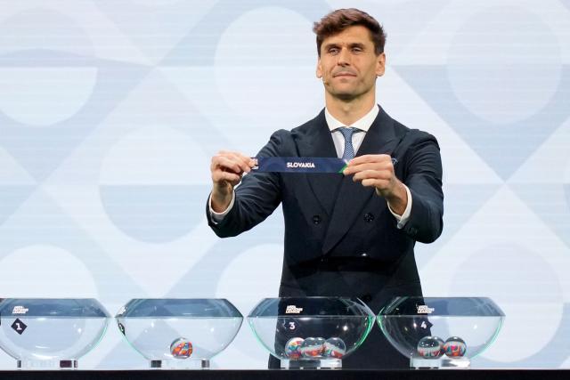 Former Spanish international Fernando Llorente shows up the paper slip for Slovakia during the 2026/27 UEFA Nations League league phase group C draw ceremony as part of the European football governing body's 50th annual Ordinary Congress in Brussels on February 12, 2026. (Photo by Pau BARRENA / AFP)