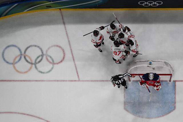 Canada's #29 Nathan Mackinnon celebrates with teammates after scoring his team fourth goal during the men's preliminary round Group A Ice Hockey match between Czech Republic and Canada at the Milano Santagiulia Ice Hockey Arena during the Milano Cortina 2026 Winter Olympic Games in Milan, on February 12, 2026. (Photo by Alexander NEMENOV / AFP)