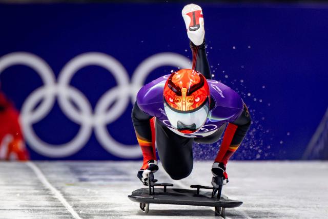 China's Yin Zheng competes in the skeleton men's heat 1 at Cortina Sliding Centre during the Milano Cortina 2026 Winter Olympic Games in Cortina d'Ampezzo on February 12, 2026. (Photo by Odd ANDERSEN / AFP)