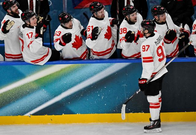 Canada's #97 Connor Mcdavid celebrates with teammates after his teammate Canada's #29 Nathan Mackinnon scored their team fourth goal during the men's preliminary round Group A Ice Hockey match between Czech Republic and Canada at the Milano Santagiulia Ice Hockey Arena during the Milano Cortina 2026 Winter Olympic Games in Milan, on February 12, 2026. (Photo by Alexander NEMENOV / AFP)