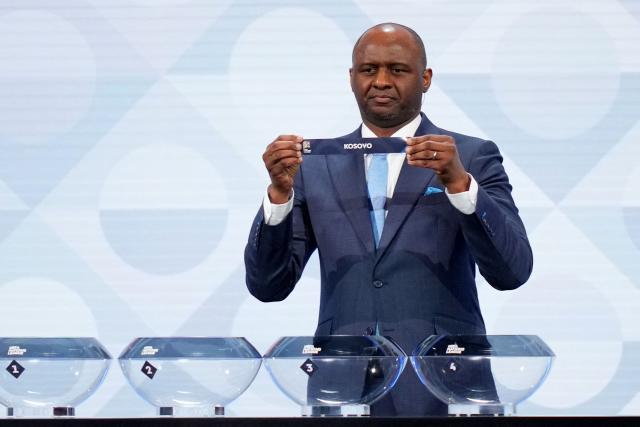 Former French international Patrick Vieira shows up the paper slip for Kosovo during the 2026/27 UEFA Nations League league phase group B draw ceremony as part of the European football governing body's 50th annual Ordinary Congress in Brussels on February 12, 2026. (Photo by Pau BARRENA / AFP)
