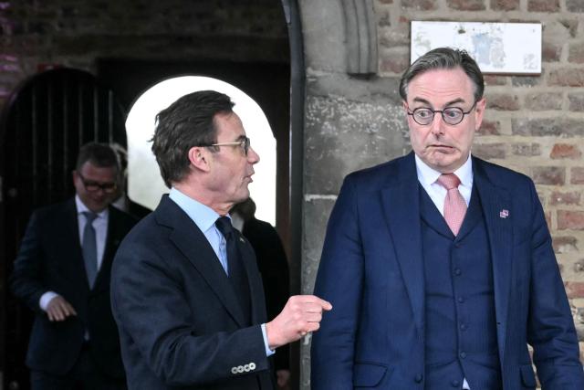 Sweden's Prime Minister Ulf Kristersson (L) and Belgium's Prime Minister Bart De Wever (R) arrive for a working session during the Informal EU Leaders' Retreat at the Alden Biesen Castle, in Rijkhoven on February 12, 2026. (Photo by NICOLAS TUCAT / AFP)