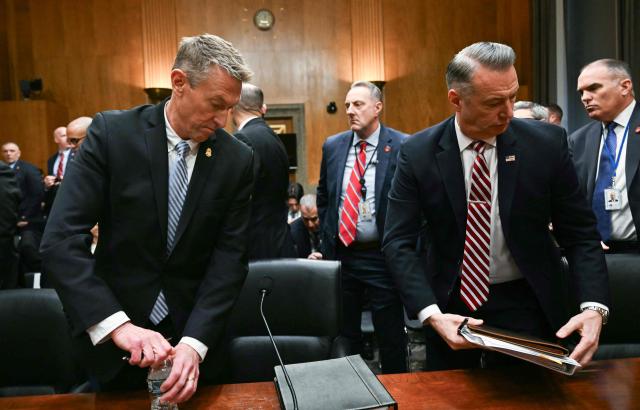 US Customs and Border Protection (CBP) Commissioner Rodney Scott (L) and Acting Director of US Immigration and Customs Enforcement (ICE) Todd Lyons (R) leave after the Senate Homeland Security and Governmental Affairs Committee in an oversight hearing amid scrutiny over immigration enforcement and recent developments in Minnesota at the Dirksen Senate Office Building in Washington, DC on February 12, 2026. (Photo by Brendan SMIALOWSKI / AFP)