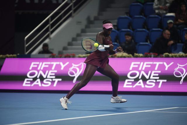 Canada's Victoria Mboko hits a return against Kazakhstan's Elena Rybakina during their women’s singles quarter-final match at the Qatar Open tennis tournament in Doha on February 12, 2026. (Photo by Karim JAAFAR / AFP)