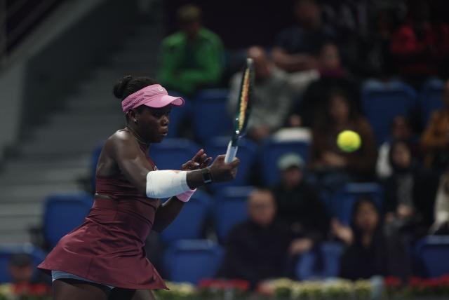 Canada's Victoria Mboko hits a return against Kazakhstan's Elena Rybakina during their women’s singles quarter-final match at the Qatar Open tennis tournament in Doha on February 12, 2026. (Photo by Karim JAAFAR / AFP)