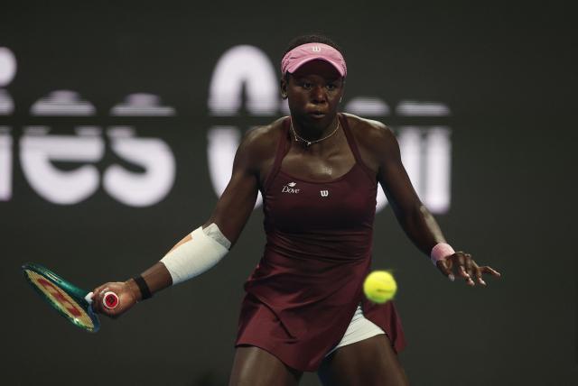 Canada's Victoria Mboko hits a return against Kazakhstan's Elena Rybakina during their women’s singles quarter-final match at the Qatar Open tennis tournament in Doha on February 12, 2026. (Photo by Karim JAAFAR / AFP)