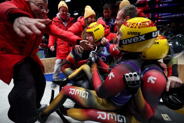Team Germany celebrate after competing in the luge team mixed relay at Cortina Sliding Centre during the Milano Cortina 2026 Winter Olympic Games in Cortina d'Ampezzo on February 12, 2026. (Photo by FRANCK FIFE / AFP)