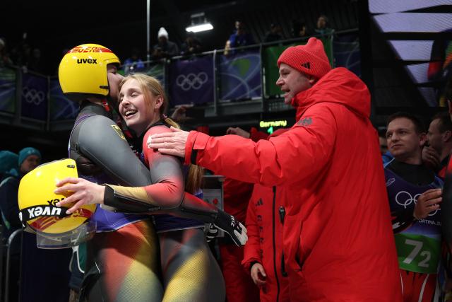 Germany's Dajana Eitberger and Germany's Magdalena Matschina celebrate after competing in the luge team mixed relay at Cortina Sliding Centre during the Milano Cortina 2026 Winter Olympic Games in Cortina d'Ampezzo on February 12, 2026. (Photo by FRANCK FIFE / AFP)