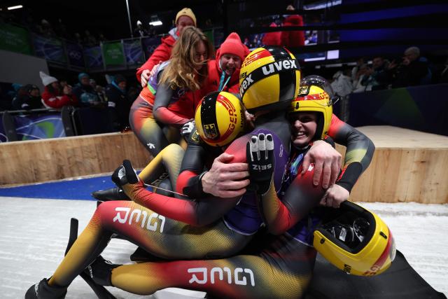 Team Germany celebrate after competing in the luge team mixed relay at Cortina Sliding Centre during the Milano Cortina 2026 Winter Olympic Games in Cortina d'Ampezzo on February 12, 2026. (Photo by FRANCK FIFE / AFP)