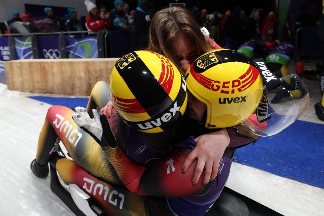 Germany's Dajana Eitberger and Germany's Magdalena Matschina celebrate after competing in the luge team mixed relay at Cortina Sliding Centre during the Milano Cortina 2026 Winter Olympic Games in Cortina d'Ampezzo on February 12, 2026. (Photo by FRANCK FIFE / AFP)