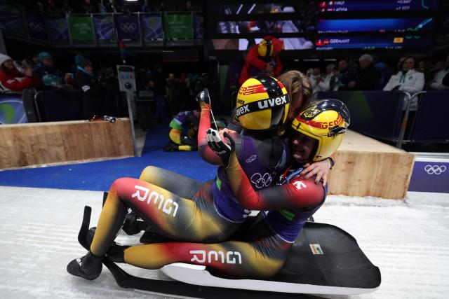 Germany's Dajana Eitberger and Germany's Magdalena Matschina celebrate after competing in the luge team mixed relay at Cortina Sliding Centre during the Milano Cortina 2026 Winter Olympic Games in Cortina d'Ampezzo on February 12, 2026. (Photo by FRANCK FIFE / AFP)