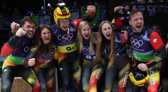 TOPSHOT - Germany's Tobias Arlt, Germany's Julia Taubitz, Germany's Max Langenhan, Germany's Dajana Eitberger, Germany's Magdalena Matschina and Germany's Tobias Wendl celebrate after competing in the luge team mixed relay at Cortina Sliding Centre during the Milano Cortina 2026 Winter Olympic Games in Cortina d'Ampezzo on February 12, 2026. (Photo by FRANCK FIFE / AFP)
