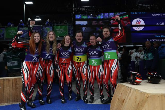 Austria's Thomas Steu, Austria's Lara Michaela Kipp, Austria's Selina Egle, Austria's Lisa Schulte, Austria's Jonas Mueller and Austria's Wolfgang Kindl react after competing in the luge team mixed relay at Cortina Sliding Centre during the Milano Cortina 2026 Winter Olympic Games in Cortina d'Ampezzo on February 12, 2026. (Photo by FRANCK FIFE / AFP)