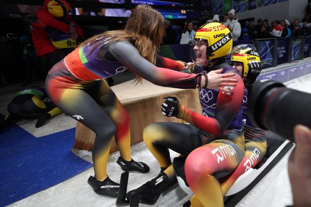 Germany's Dajana Eitberger and Germany's Magdalena Matschina celebrate after competing in the luge team mixed relay at Cortina Sliding Centre during the Milano Cortina 2026 Winter Olympic Games in Cortina d'Ampezzo on February 12, 2026. (Photo by FRANCK FIFE / AFP)
