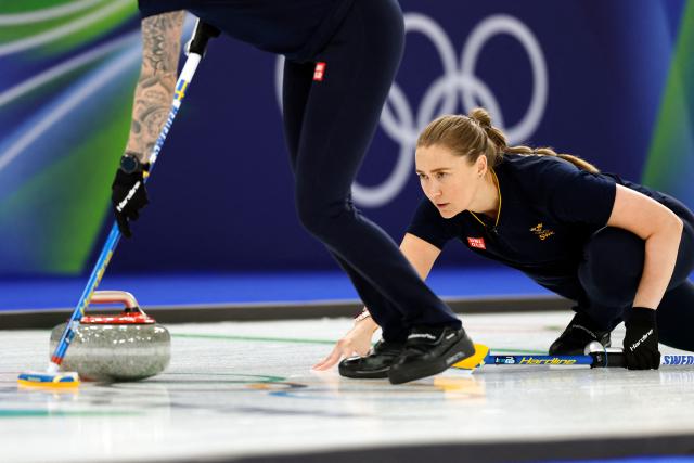Sweden's Sara McManus delivers the stone during the curling women's round robin between Sweden and USA during the Milano Cortina 2026 Winter Olympic Games at the Cortina Curling Olympic Stadium in Cortina d’Ampezzo on February 12, 2026. (Photo by Odd ANDERSEN / AFP)